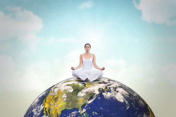 woman meditating on top of Earth