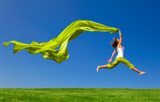 woman jumping with green scarf