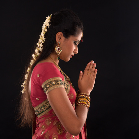 Woman in sari praying