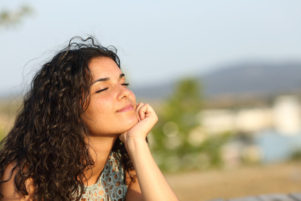Woman peacefully contemplating outdoors
