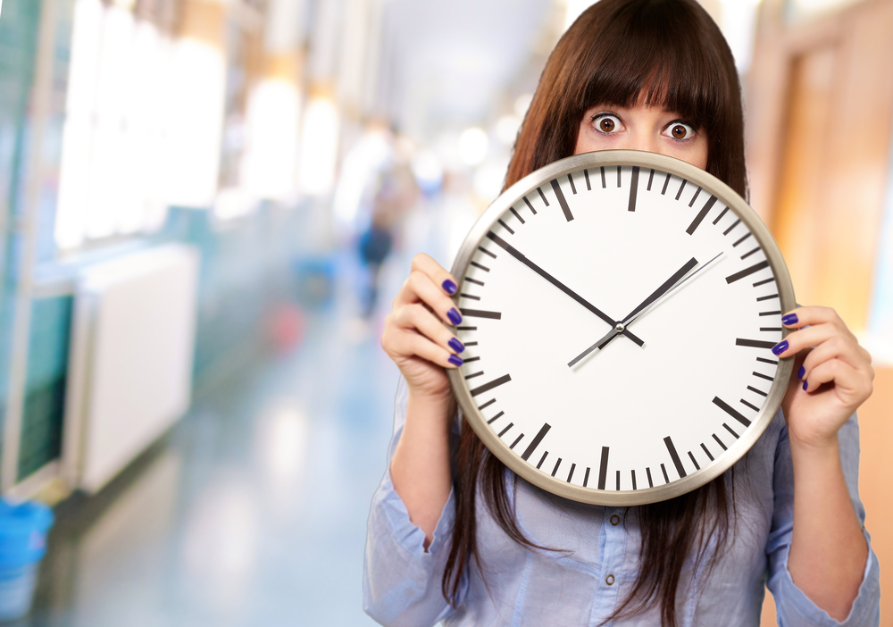 overwhelmed woman holding clock