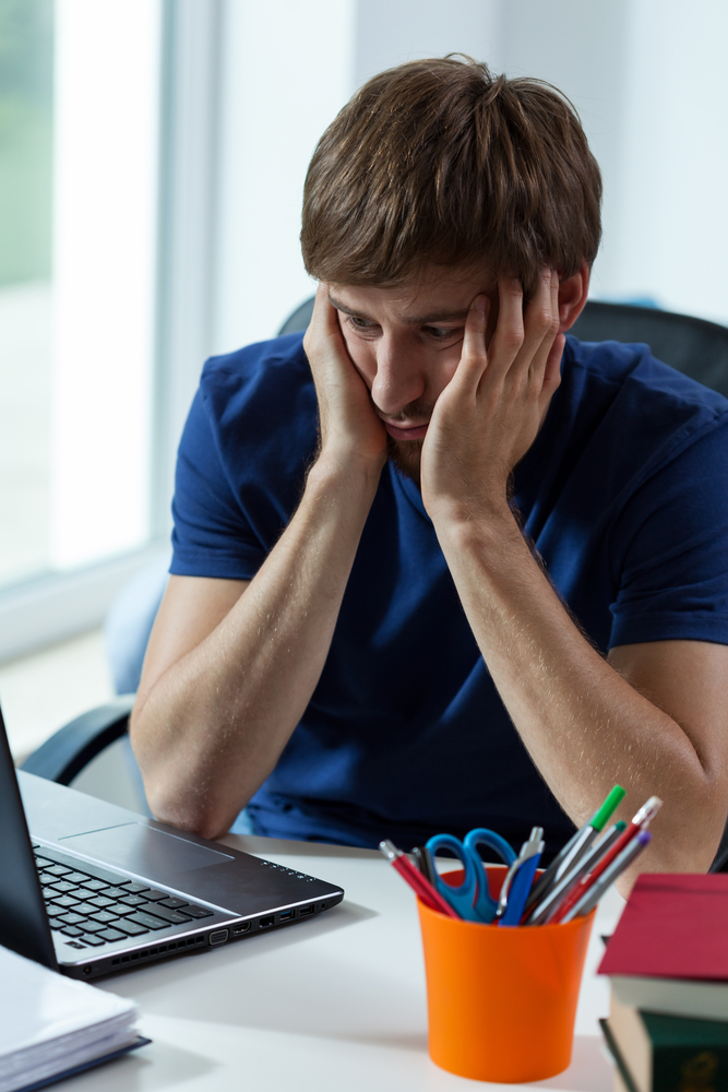 man looking disengaged from work