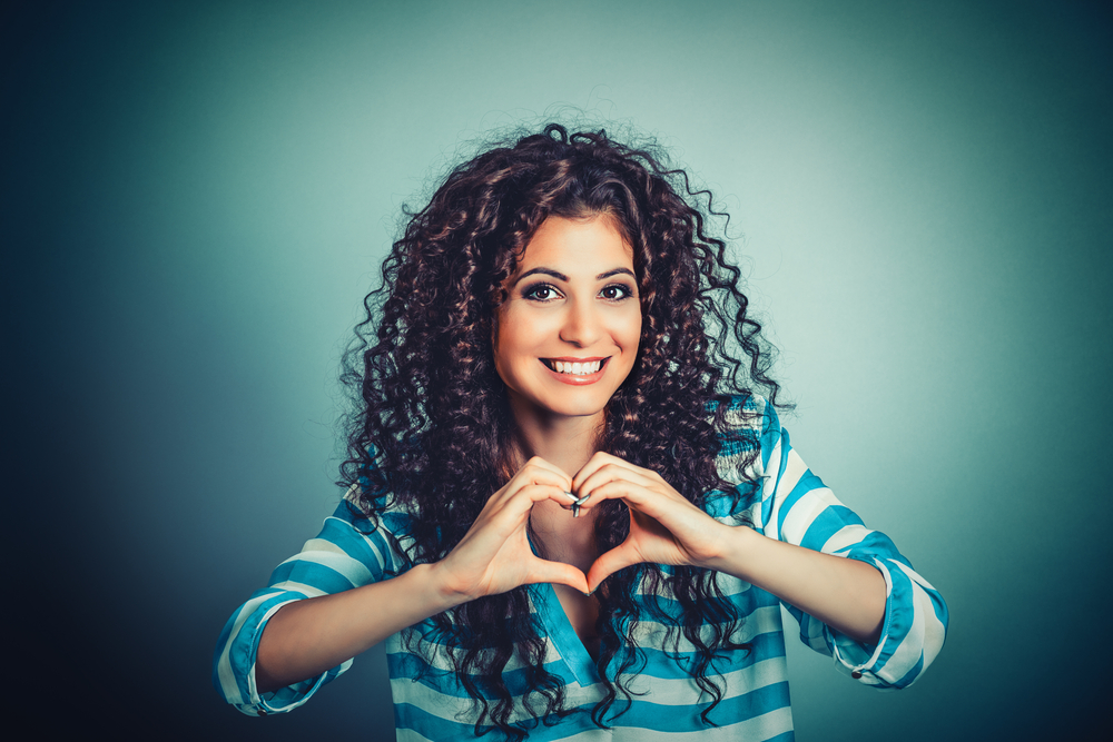 woman making heart shape with hands