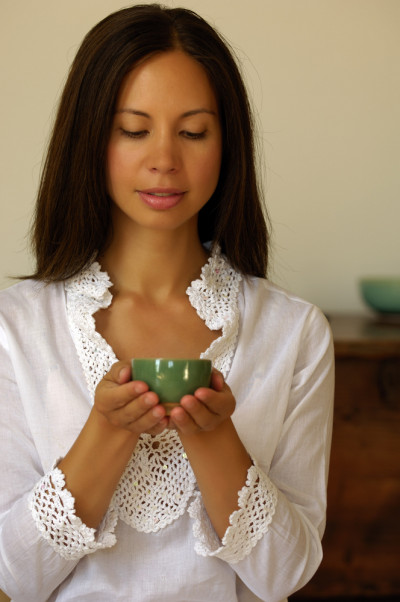 peaceful woman holding cup of tea