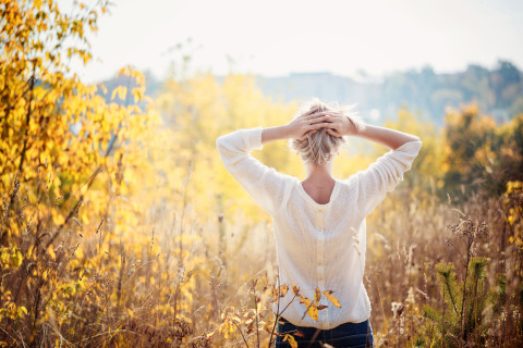 woman standing in open field