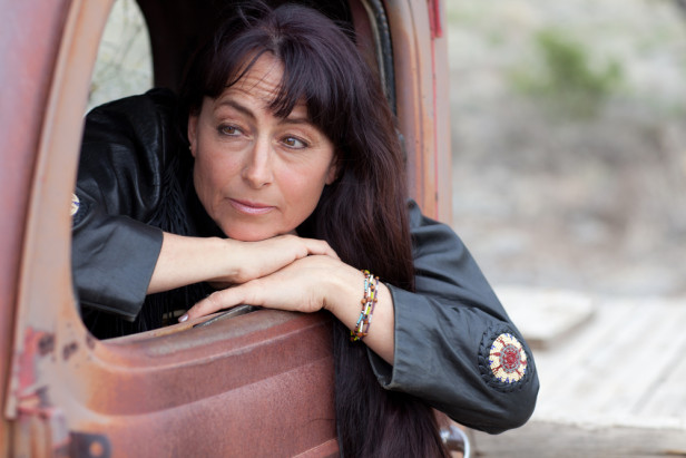 pensive woman leaning out of truck window