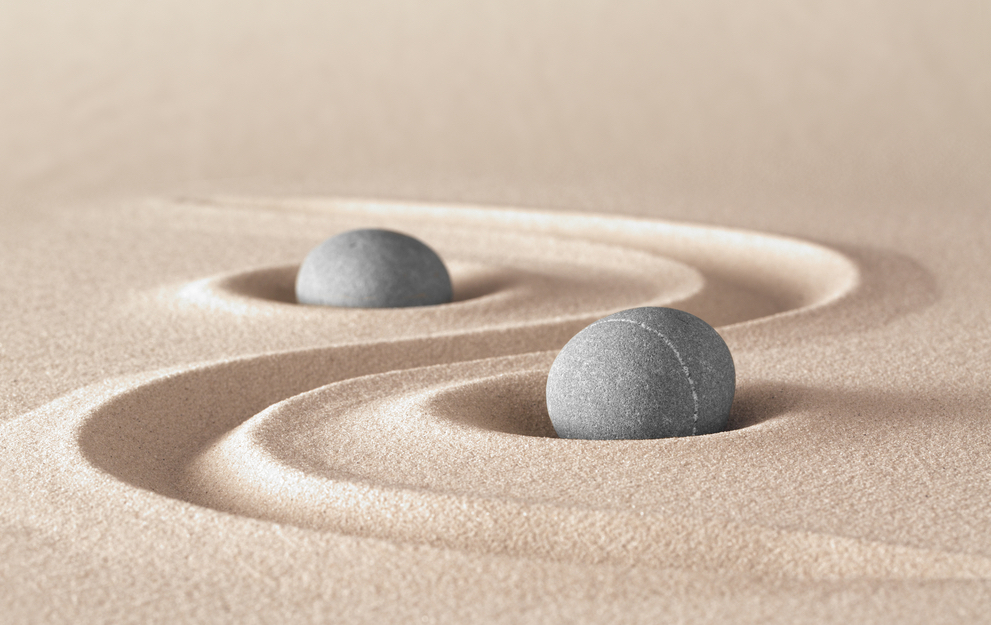 Two stones in swirls of sand. Peaceful, energetic, vitality, health, focus, zen, meditation, being free of the ego.