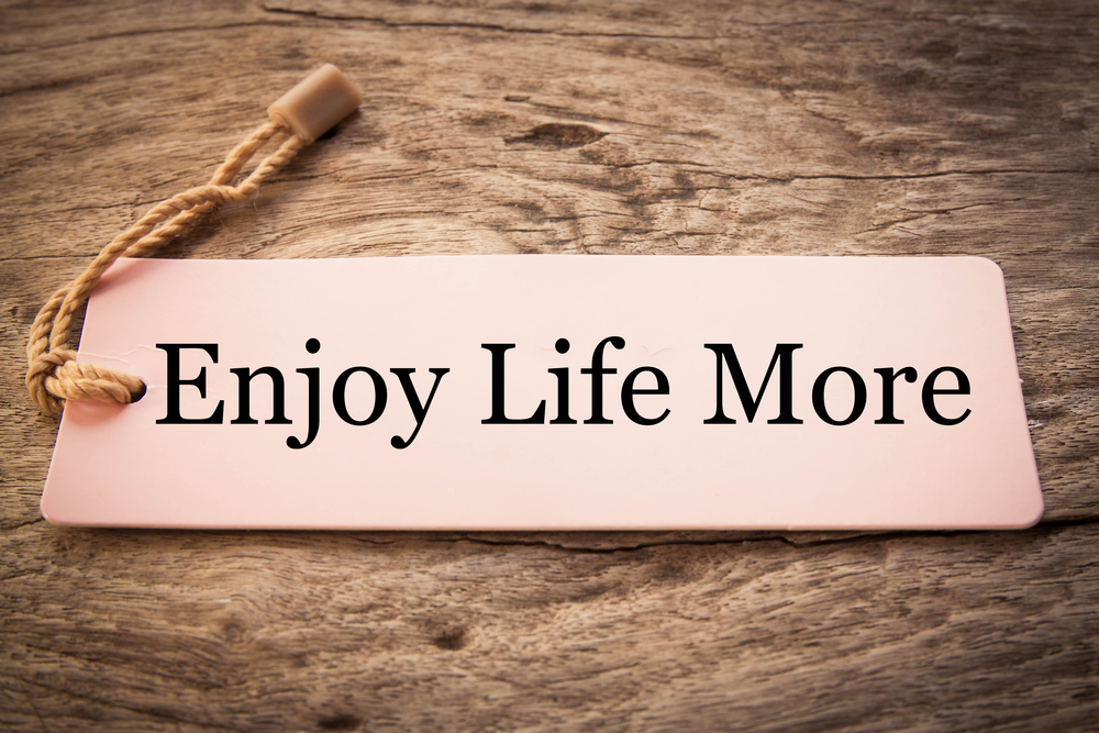 Sign saying "Enjoy Life More"