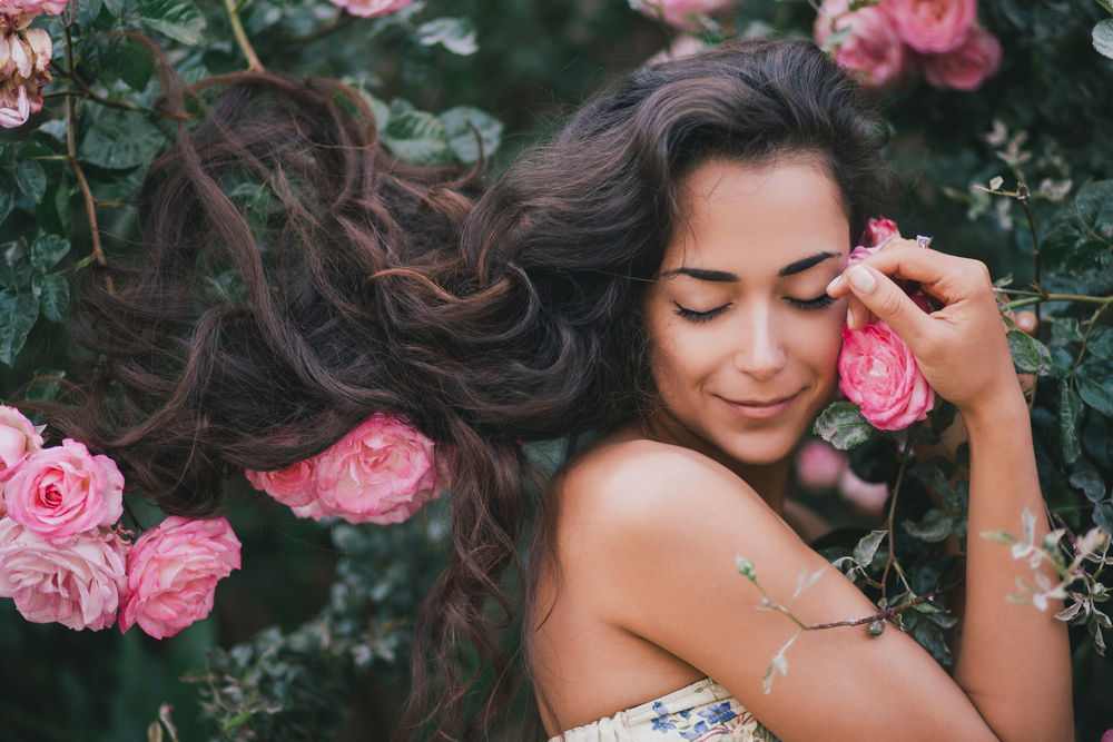 Peaceful woman with roses. True self, connecting with nature, natural humanity.
