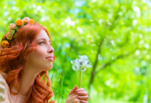 woman with dandelions - peaceful, content, harmony